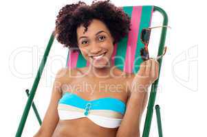 Glamorous woman in lingerie relaxing on a deckchair