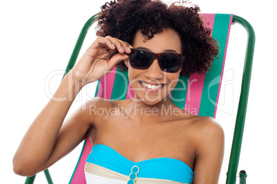 Relaxing female model adjusting her shades