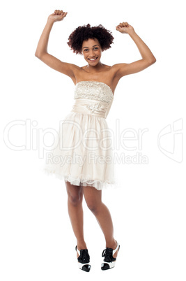 Delighted young lady partying and dancing