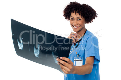 Attractive young medical professional holding x-ray sheet