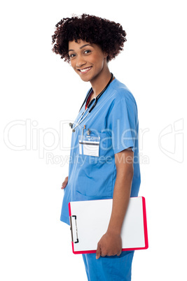Smiling medical professional holding blank clipboard
