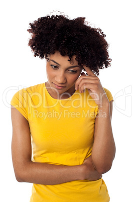 Calm and thoughtful curly haired young woman