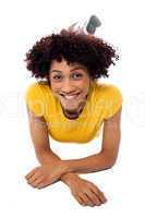 Woman in yellow top relaxing on studio floor