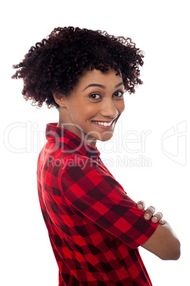 Side profile of slim young smiling woman, arms crossed