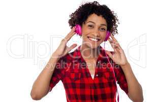 Smiling woman with pink headphones on