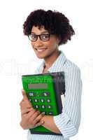 Young businesswoman with calculator and file