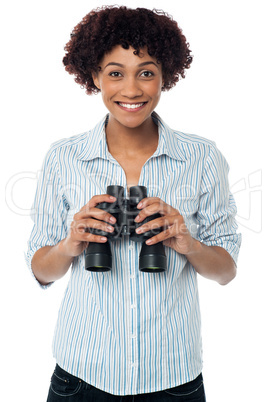 Smiling afro american woman holding binocular