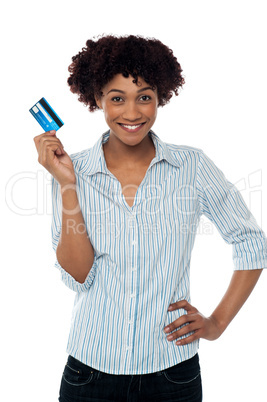 Cheerful lady in casuals holding up cash card