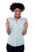 Excited woman gesturing double thumbs up