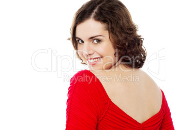 Flirtatious female turning back and passing smile