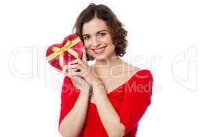 Woman closely holding gift from her boyfriend