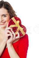 Cropped image of smiling woman holding present