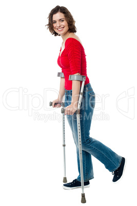 Woman walking with the help of crutches