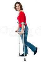 Woman walking with the help of crutches