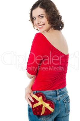 Pretty model posing with gift in her back pocket