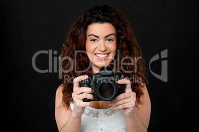 Cheerful woman holding newly launched camera