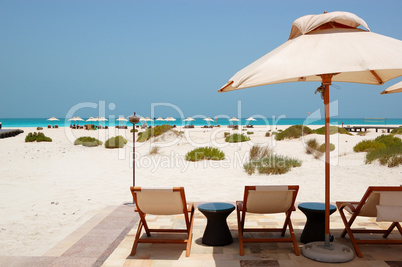 Sunbeds and umbrellas at the Beach of luxury hotel, Abu Dhabi, U