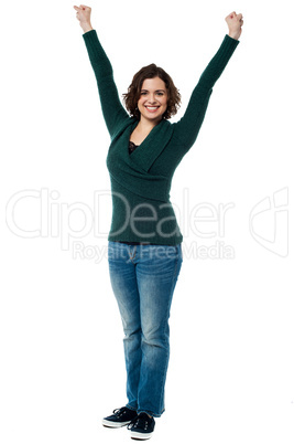 Jubilant woman with raised arms celebrating victory