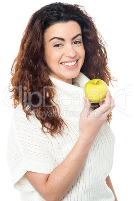 Joyous woman with an apple in hand