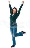 Delighted young woman dancing with joy