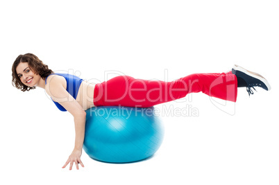 Attractive woman exercising with swiss ball