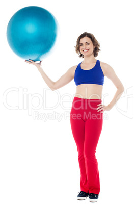 Lady gym instructor holding pilates ball