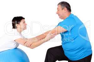 Man and woman with exercise ball