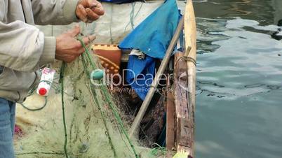 Fisherman Repairs Fishnet