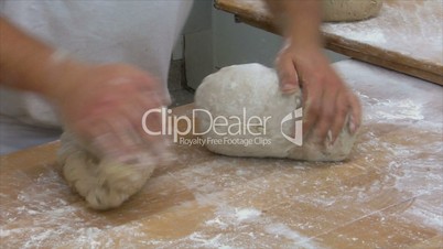 german baker kneading two bread slow motion 10831