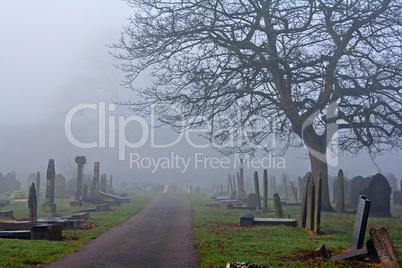 Spooky old cemetery on a foggy day