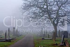 Spooky old cemetery on a foggy day