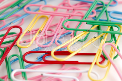 Colored paper clips on white