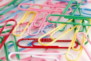 Colored paper clips on white