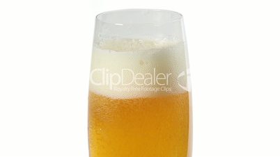 Cider with bubbles in glass isolated on white