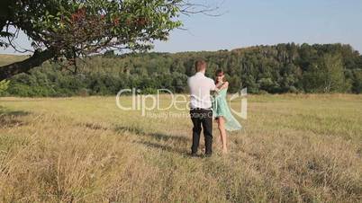 Man and woman dancing in the field