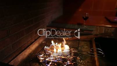 Barbecue with fire and glass of wine