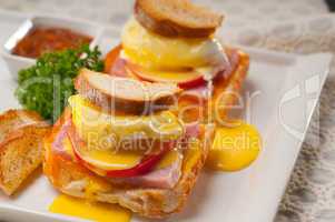 eggs benedict on bread with tomato and ham