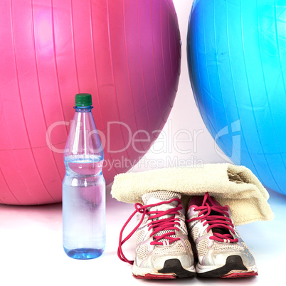 Exercise balls with sneakers and a water bottle