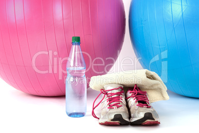 Exercise balls with sneakers and a water bottle