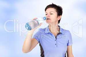 Sporty woman drinking from water bottle