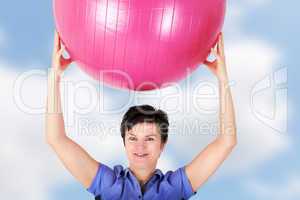 Sporty woman doing exercise with gym ball