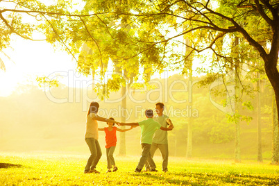 Happy Asian family playing