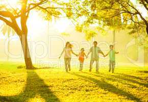 Asian family holding hands running