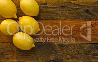 Fresh ripe lemons on rustic wooden table