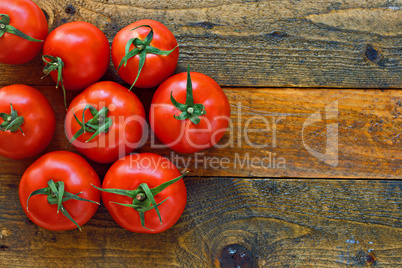 Fresh ripe tomatoes on a rustic wooden table