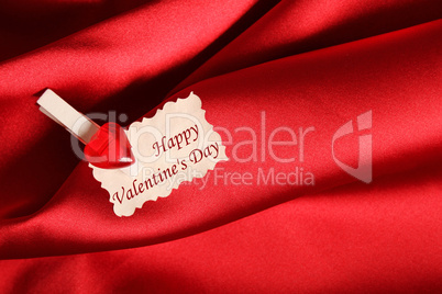 Greeting card for Valentine's Day, on red satin