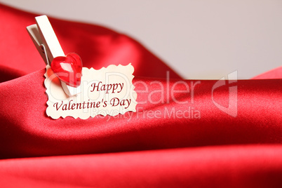 Greeting card for Valentine's Day, on red satin