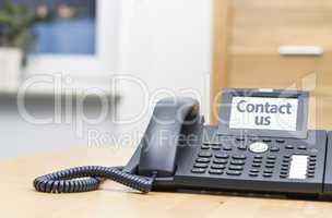 telephone with digital display on wooden desk