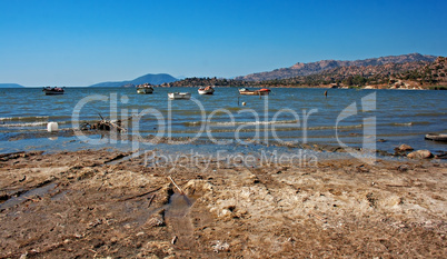 Small fishing boats on a lake in the afternoon sun