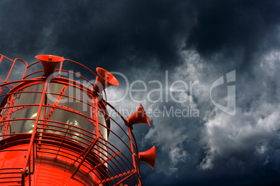 Red lightship with fog horns against storm clouds